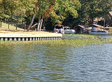 Vinyl sheet piling wall installed along water edge to create a clean stable boundary
